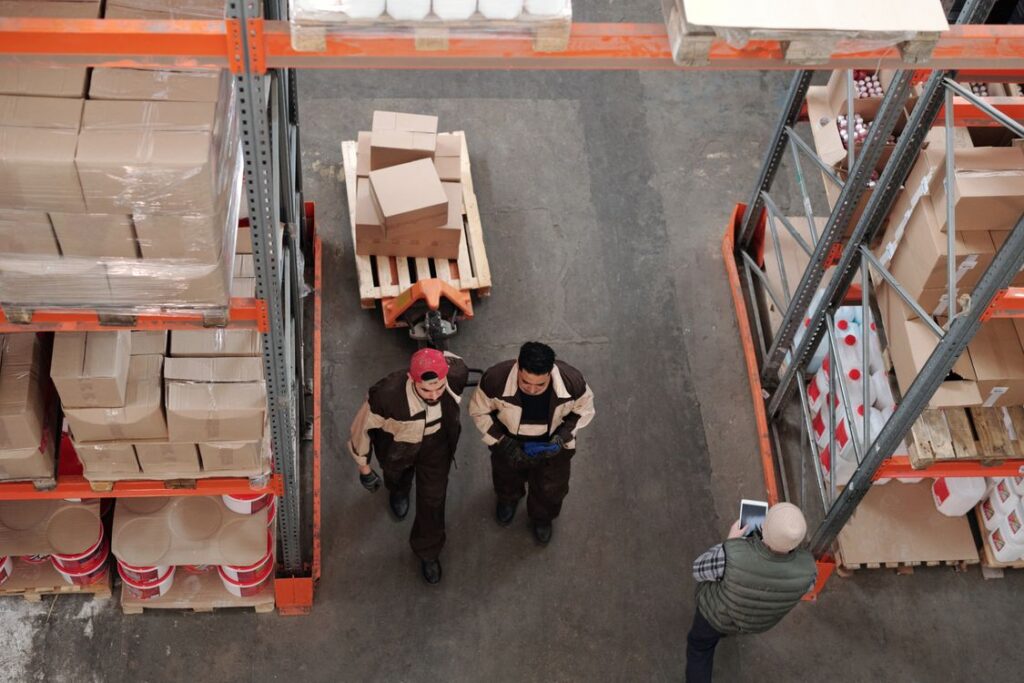 Warehouse workers preparing shipments with boxes and pallets